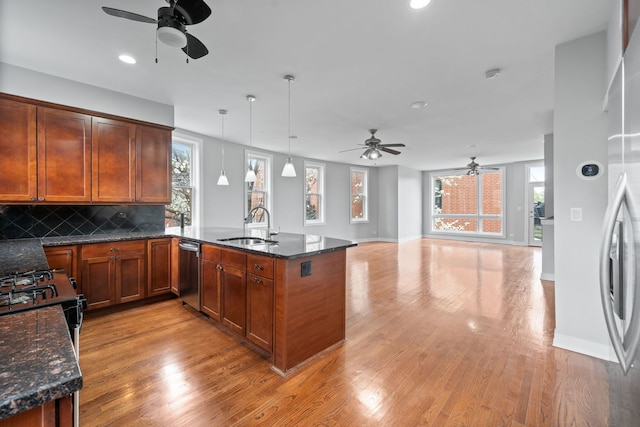 2864 N Riverwalk Dr, Chicago, IL 60618 - kitchen with a ceiling fan, dishwasher, light wood-style floors, a peninsula, and decorative backsplash