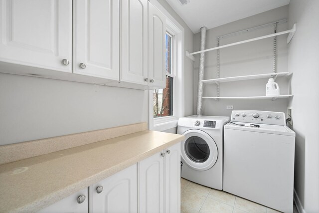 2864 N Riverwalk Dr, Chicago, IL 60618 - laundry room with washer and clothes dryer, cabinet space, and light tile patterned flooring