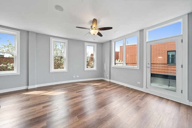 2864 N Riverwalk Dr, Chicago, IL 60618 - spare room featuring wood finished floors, plenty of natural light, and ceiling fan