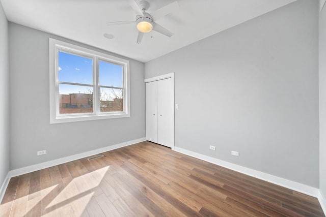 2864 N Riverwalk Dr, Chicago, IL 60618 - unfurnished room featuring wood finished floors and a ceiling fan