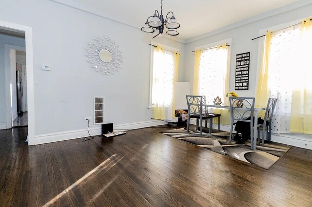 5523 W Huron St, Chicago, IL 60644 - dining area featuring a chandelier and wood finished floors