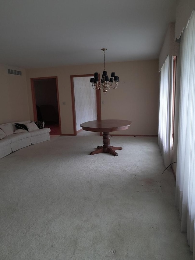 154 E US Highway 34, Mendota, IL 61342 - unfurnished dining area featuring a chandelier and light colored carpet