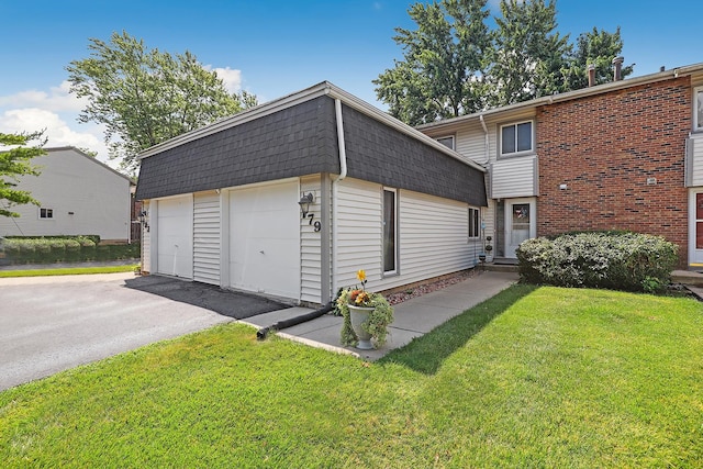 179 Roberts Rd, Bolingbrook, IL 60440 - view of home's exterior with a garage, a yard, and mansard roof