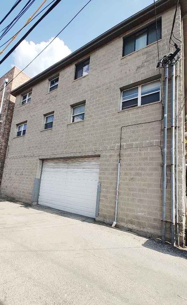 222 W 26th St Unit 202, Chicago, IL 60616 - view of property featuring an attached garage and driveway