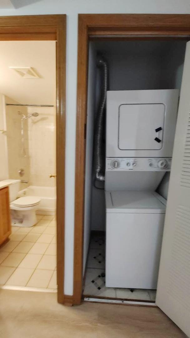 222 W 26th St Unit 202, Chicago, IL 60616 - laundry area featuring estacked washer and dryer and light tile patterned floors