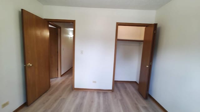 222 W 26th St Unit 202, Chicago, IL 60616 - unfurnished bedroom featuring light wood-style floors and a closet