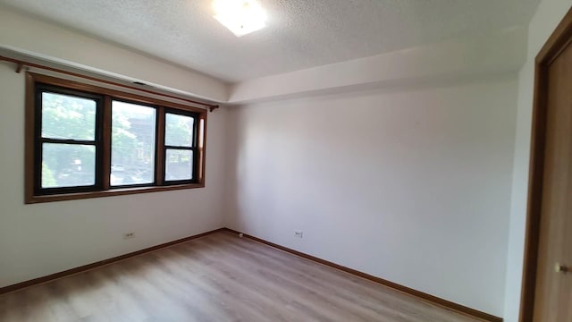222 W 26th St Unit 202, Chicago, IL 60616 - unfurnished room featuring a textured ceiling and light wood finished floors