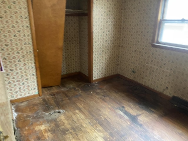 9221 S Normal Ave, Chicago, IL 60620 - unfurnished bedroom with wood-type flooring, a closet, and wallpapered walls