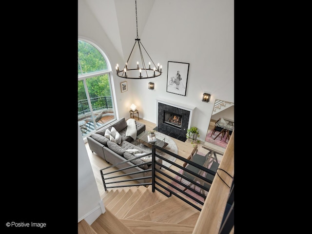 2026 W Pierce Ave Unit 7, Chicago, IL 60622 - living area featuring a tiled fireplace, a chandelier, and vaulted ceiling