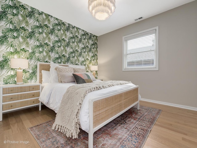 2026 W Pierce Ave Unit 7, Chicago, IL 60622 - bedroom with wallpapered walls, wood finished floors, and an accent wall
