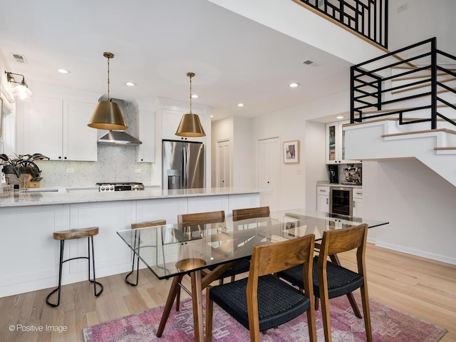 2026 W Pierce Ave Unit 7, Chicago, IL 60622 - dining area with beverage cooler, light wood-type flooring, stairway, and recessed lighting