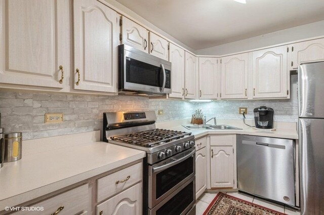 2005 Valencia Dr Unit 301, Northbrook, IL 60062 - kitchen featuring appliances with stainless steel finishes, light countertops, and tasteful backsplash