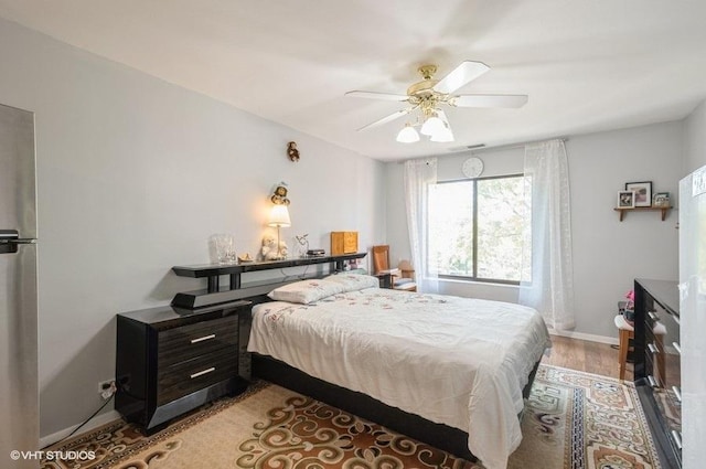 2005 Valencia Dr Unit 301, Northbrook, IL 60062 - bedroom featuring wood finished floors, freestanding refrigerator, and ceiling fan