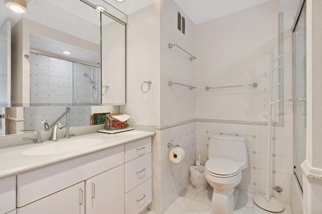 505 N Lake Shore Dr Unit 408, Chicago, IL 60611 - bathroom with tile walls, vanity, tile patterned flooring, wainscoting, and enclosed tub / shower combo