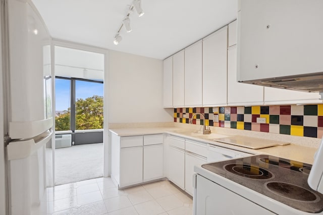 505 N Lake Shore Dr Unit 408, Chicago, IL 60611 - kitchen with light carpet, white cabinets, track lighting, and light tile patterned flooring