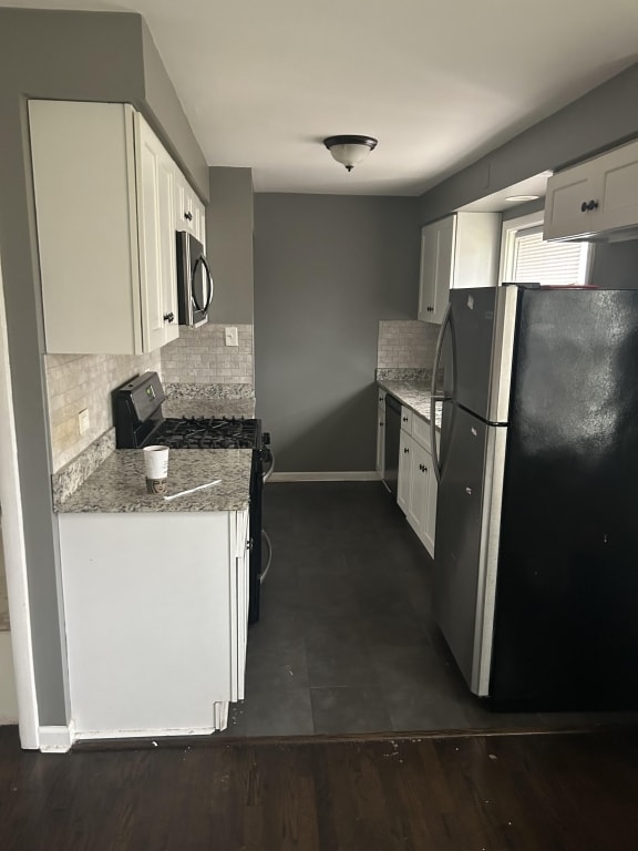 248 W Elmwood Dr, Chicago Heights, IL 60411 - kitchen featuring freestanding refrigerator, range with gas cooktop, decorative backsplash, white cabinets, and light stone countertops