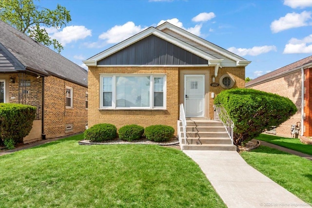 2552 W 117th Pl, Chicago, IL 60655 - bungalow featuring brick siding, a front lawn, and board and batten siding
