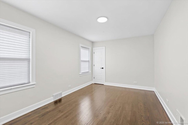2552 W 117th Pl, Chicago, IL 60655 - empty room featuring dark wood-style flooring and baseboards