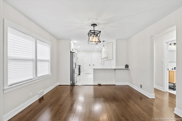 2552 W 117th Pl, Chicago, IL 60655 - unfurnished living room with dark wood-type flooring, a chandelier, and recessed lighting