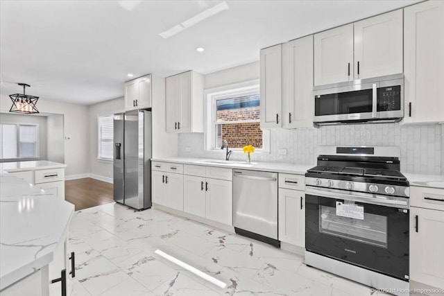 2552 W 117th Pl, Chicago, IL 60655 - kitchen with appliances with stainless steel finishes, white cabinetry, tasteful backsplash, decorative light fixtures, and light marble finish floors