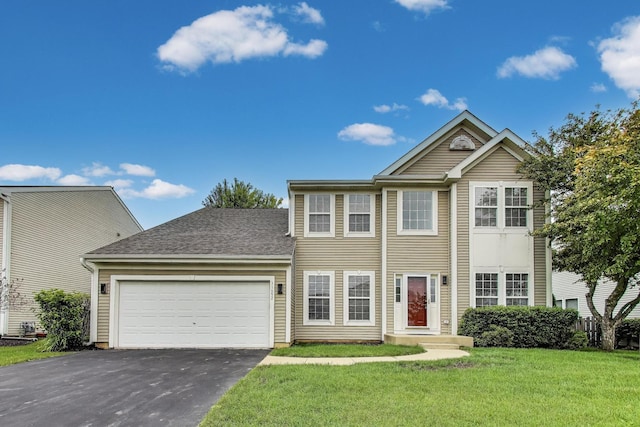31692 N Clearwater Dr, Lakemoor, IL 60051 - view of front facade with asphalt driveway, an attached garage, a front lawn, and roof with shingles