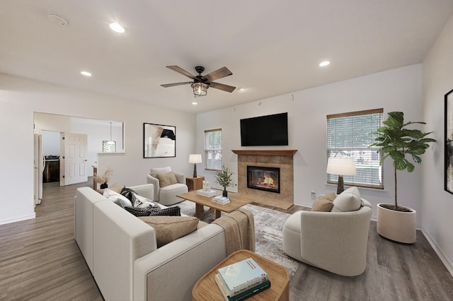 31692 N Clearwater Dr, Lakemoor, IL 60051 - living area featuring wood finished floors, a tile fireplace, a ceiling fan, and recessed lighting