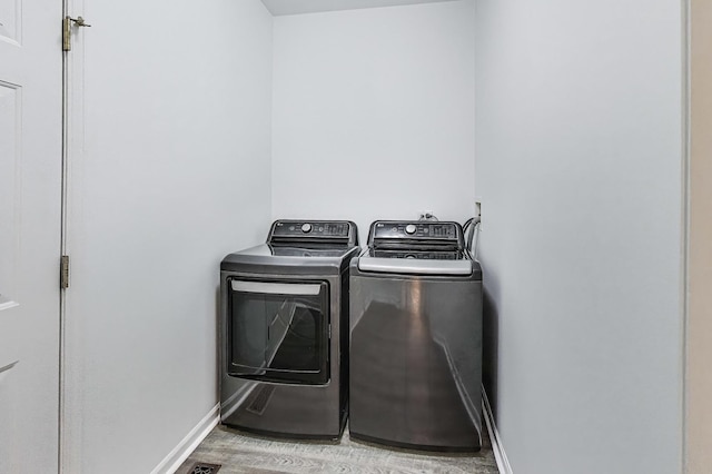 31692 N Clearwater Dr, Lakemoor, IL 60051 - washroom with washing machine and clothes dryer and light wood finished floors