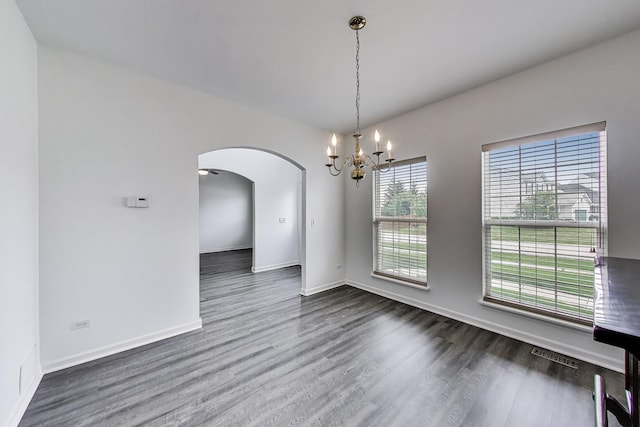 31692 N Clearwater Dr, Lakemoor, IL 60051 - unfurnished room with a chandelier, arched walkways, and wood finished floors