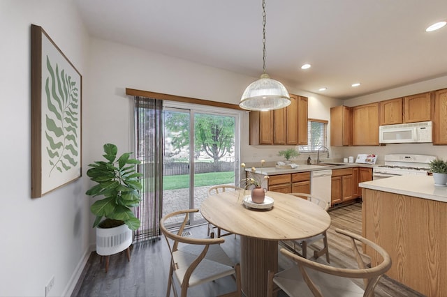 31692 N Clearwater Dr, Lakemoor, IL 60051 - kitchen with white appliances, light countertops, light wood-style flooring, recessed lighting, and decorative light fixtures