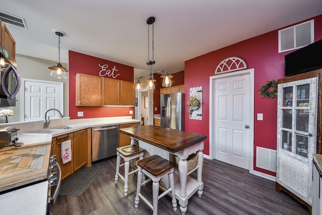 1934 Stoneheather Ave, Aurora, IL 60503 - kitchen featuring stainless steel appliances, wood counters, dark wood-style flooring, and hanging light fixtures