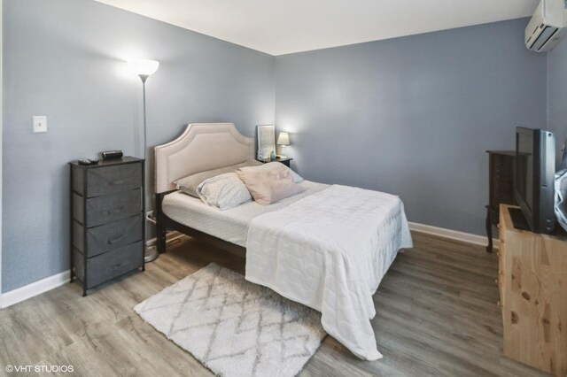 323 Marshall Rd, Bensenville, IL 60106 - bedroom featuring a wall mounted AC and wood finished floors