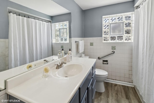 323 Marshall Rd, Bensenville, IL 60106 - full bath featuring tile walls, wood finished floors, vanity, a wainscoted wall, and a shower with shower curtain