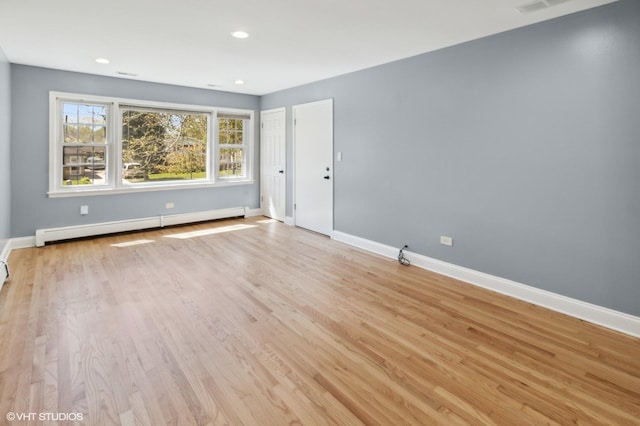 323 Marshall Rd, Bensenville, IL 60106 - empty room with a baseboard radiator, light wood-style floors, and recessed lighting