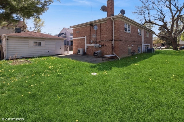 323 Marshall Rd, Bensenville, IL 60106 - back of property with a lawn, brick siding, and a chimney