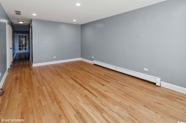 323 Marshall Rd, Bensenville, IL 60106 - spare room featuring a baseboard heating unit, light wood-type flooring, and recessed lighting