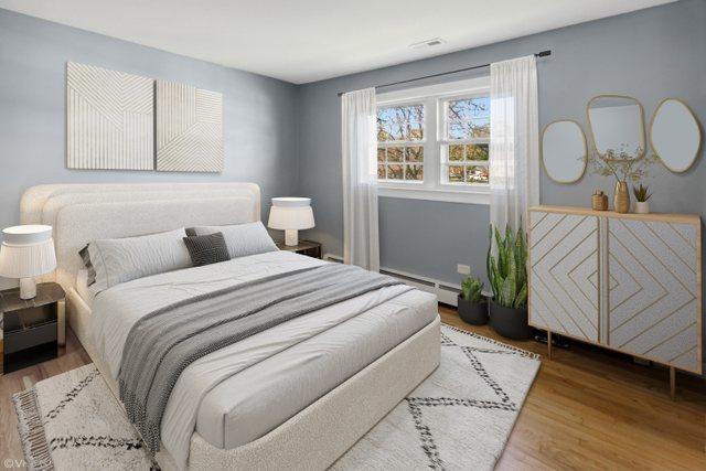 323 Marshall Rd, Bensenville, IL 60106 - bedroom featuring a baseboard radiator and wood finished floors