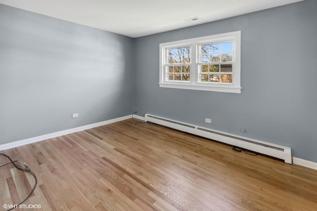 323 Marshall Rd, Bensenville, IL 60106 - empty room featuring a baseboard heating unit and light wood finished floors