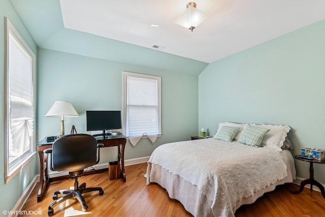 1820 N 75th Ct, Elmwood Park, IL 60707 - bedroom featuring multiple windows, wood finished floors, vaulted ceiling, and an office area