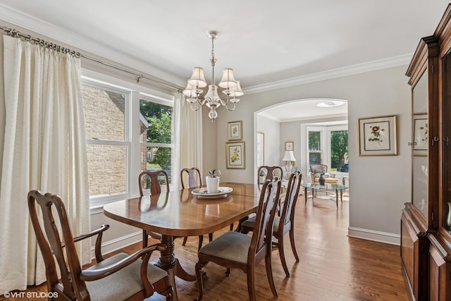 1820 N 75th Ct, Elmwood Park, IL 60707 - dining room with plenty of natural light, dark wood-style flooring, arched walkways, ornamental molding, and a chandelier