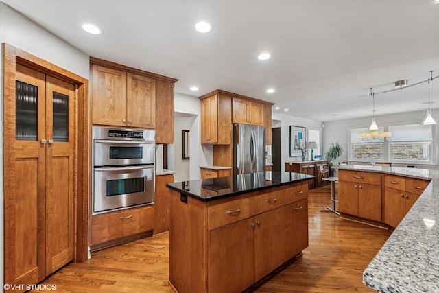 1820 N 75th Ct, Elmwood Park, IL 60707 - kitchen featuring stainless steel appliances, wood finished floors, a center island, stone countertops, and recessed lighting