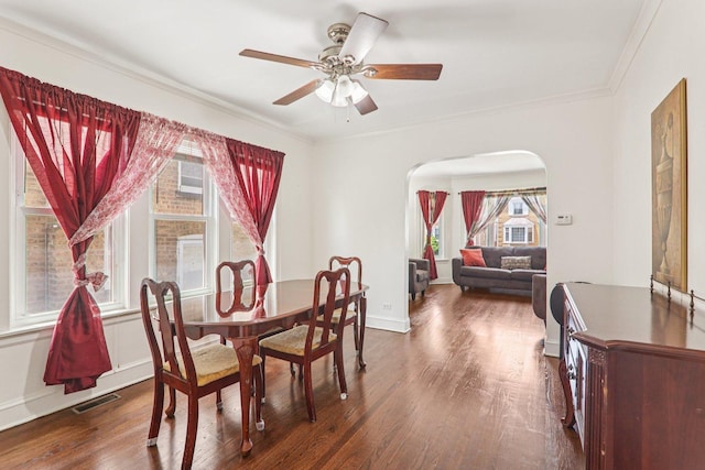 4517 N Austin Ave, Chicago, IL 60630 - dining area with arched walkways, dark wood-style flooring, ceiling fan, and crown molding
