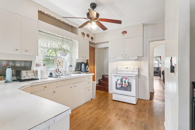 4517 N Austin Ave, Chicago, IL 60630 - kitchen with electric stove, under cabinet range hood, healthy amount of natural light, and light countertops
