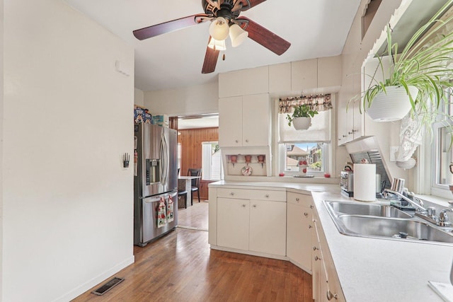 4517 N Austin Ave, Chicago, IL 60630 - kitchen featuring stainless steel refrigerator with ice dispenser, light countertops, a ceiling fan, and light wood-style floors