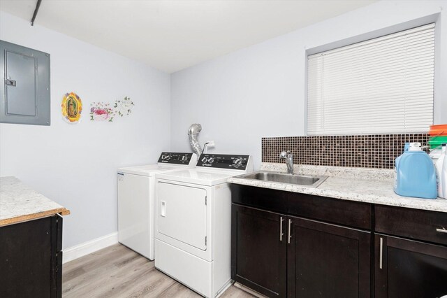 5642 W Dakin St, Chicago, IL 60634 - laundry area with electric panel, washer and dryer, cabinet space, and light wood finished floors