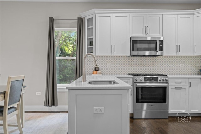657 Bourbon Ct, Naperville, IL 60565 - kitchen featuring appliances with stainless steel finishes, white cabinets, light countertops, and decorative backsplash