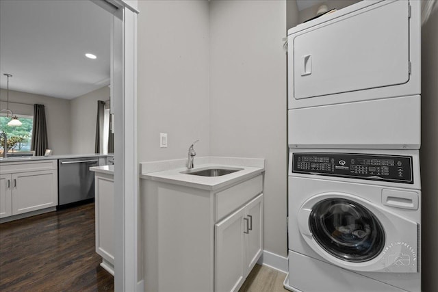 657 Bourbon Ct, Naperville, IL 60565 - laundry room featuring stacked washer and clothes dryer, dark wood-type flooring, and recessed lighting