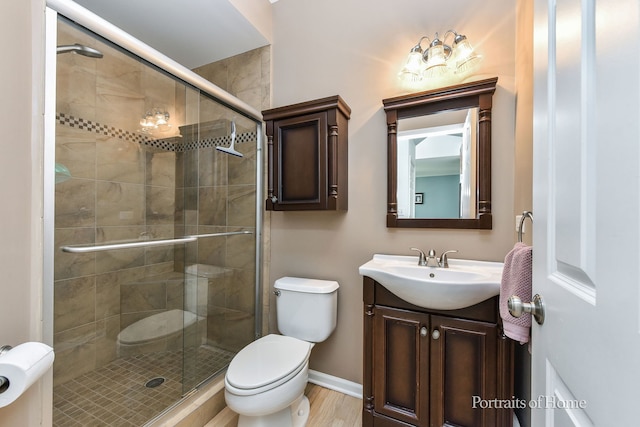 239 Morgan Valley Dr, Oswego, IL 60543 - bathroom featuring vanity, a shower stall, and wood finished floors