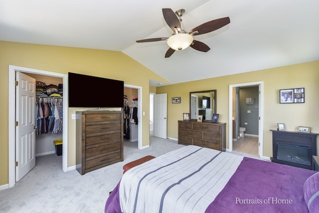 239 Morgan Valley Dr, Oswego, IL 60543 - bedroom featuring a walk in closet, lofted ceiling, light colored carpet, connected bathroom, and a ceiling fan