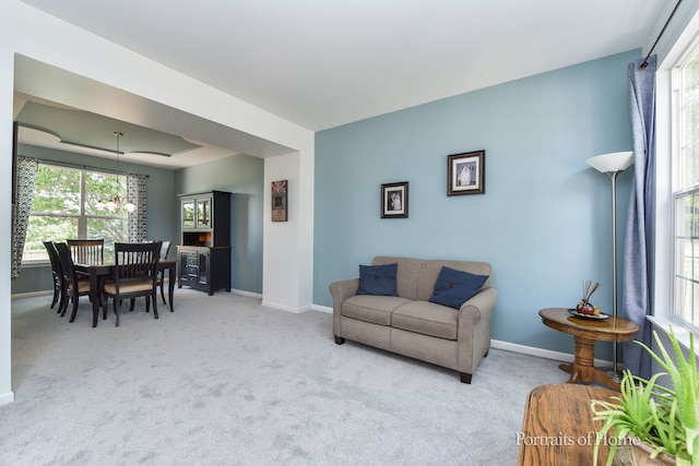 239 Morgan Valley Dr, Oswego, IL 60543 - carpeted living area with baseboards and a chandelier