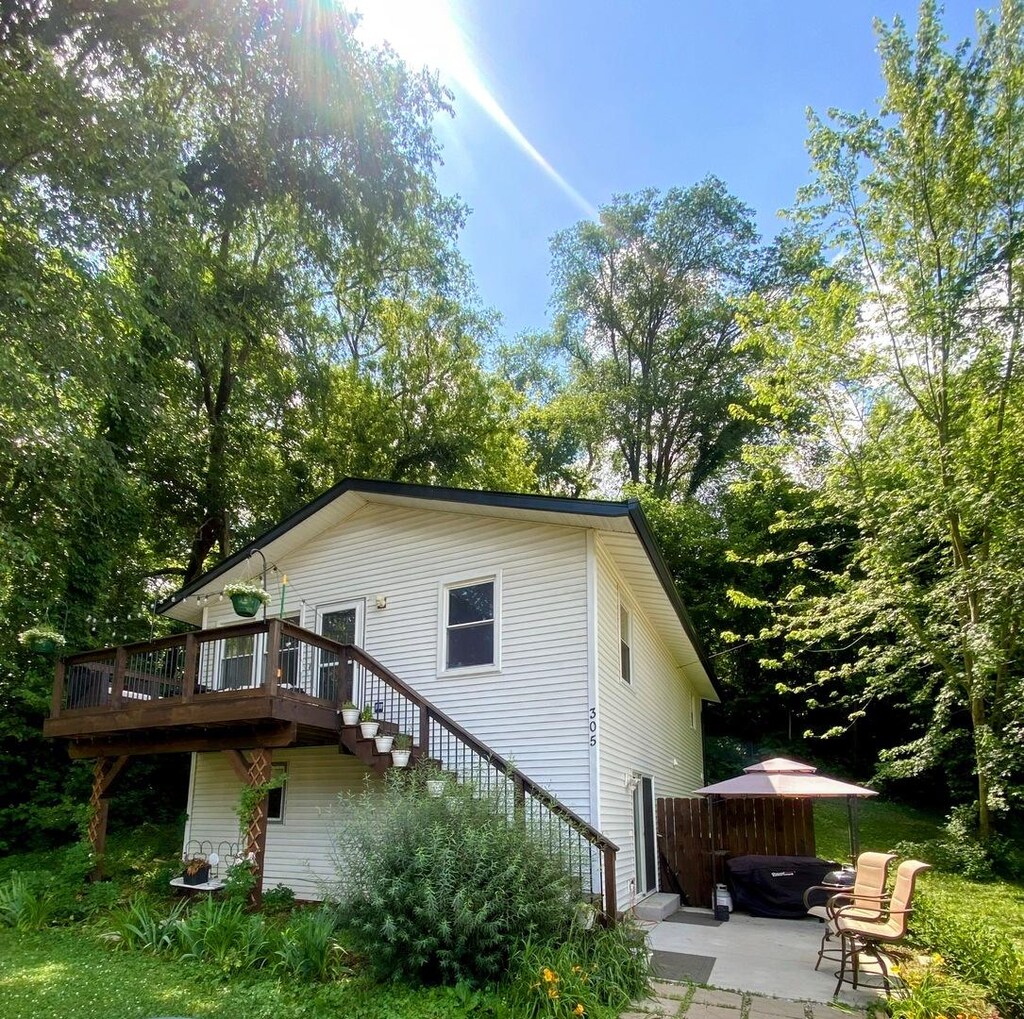305 N Blackhawk Dr, Byron, IL 61010 - view of home's exterior with stairs, a deck, and a patio